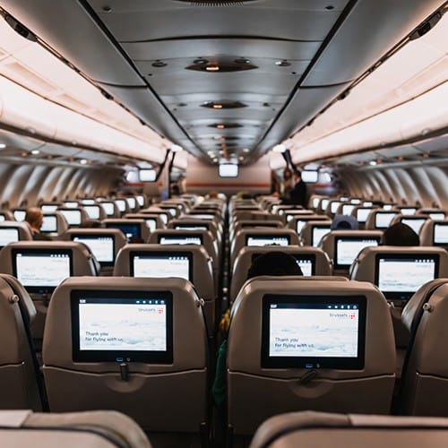 Passenger airplane with screens in the back of every seat